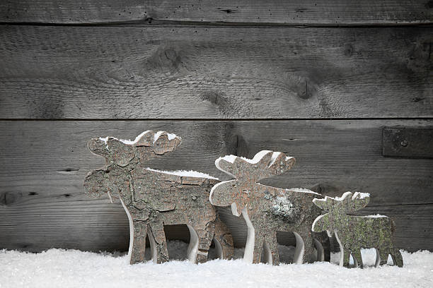 istock Three wooden elk or reindeers on a grey background 453253383