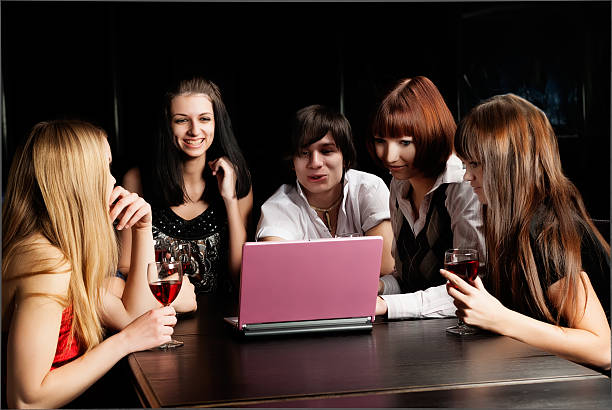 istock Group young people with laptop in cafe 453253699