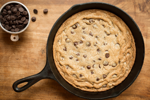 Chocolate Chip cookie baked in a cast iron skillet viewed from directly above.