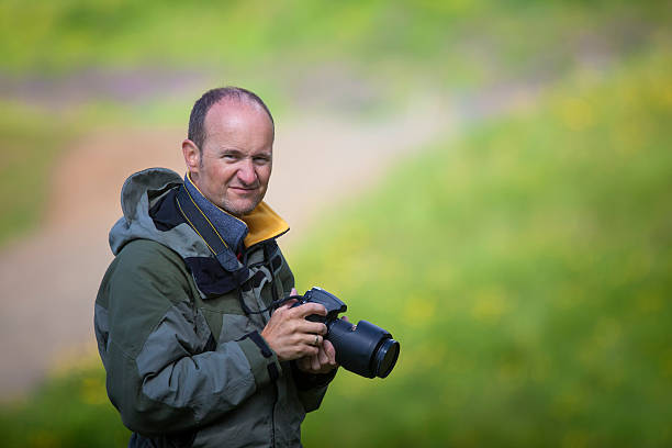 istock Man with photocamera 453257571