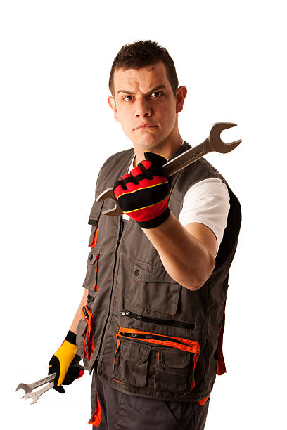 istock angry mechanic threats with wrench 453265719