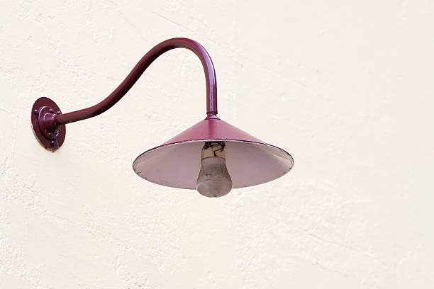 istock Old red outdoor electric lamp on white wall, copy space 453265753