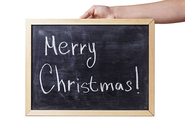 istock female hand holding chalkboard with Merry Christmas text 453265765