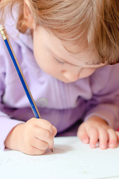 istock Little girl paints with pencil 453265875