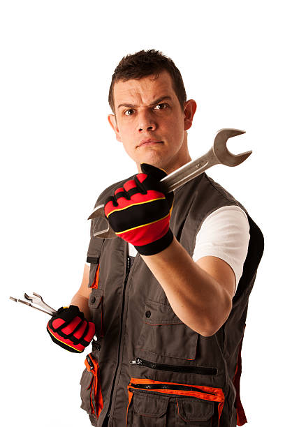istock angry mechanic threats with wrench 453265991