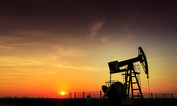 An oil and gas well operating during sunset