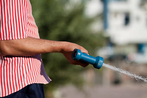 istock Water hose nozzle in the hand 453269011