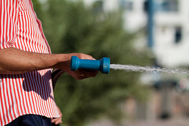 istock Water hose nozzle in the hand 453269013