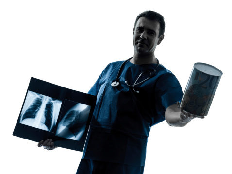 one caucasian man doctor surgeon radiologist medical worker holding a money box silhouette on white background