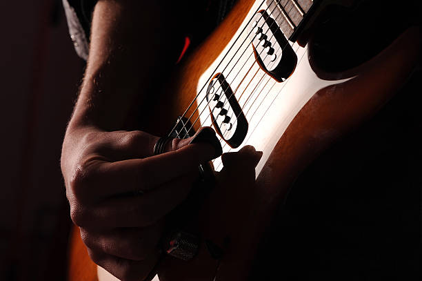 istock rock guitarist on black background 453271523