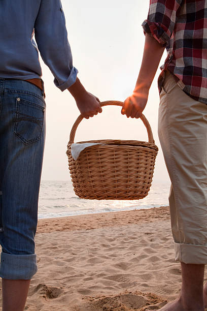 istock Young Couple Holding Picnic Basket 453272405