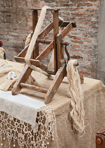 old winder machine with hank of hemp fiber - antique tool for making hemp fabric