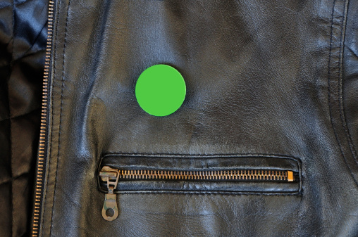 Black leather jacket with zipper and blank pin badge to add your own text or logo.