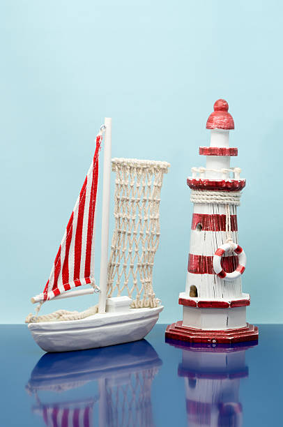 istock Antique toy sailboat and lighthouse (XXXLarge) 453276959