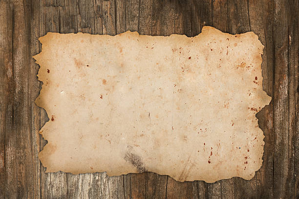 istock Weathered old paper on wood 453282519