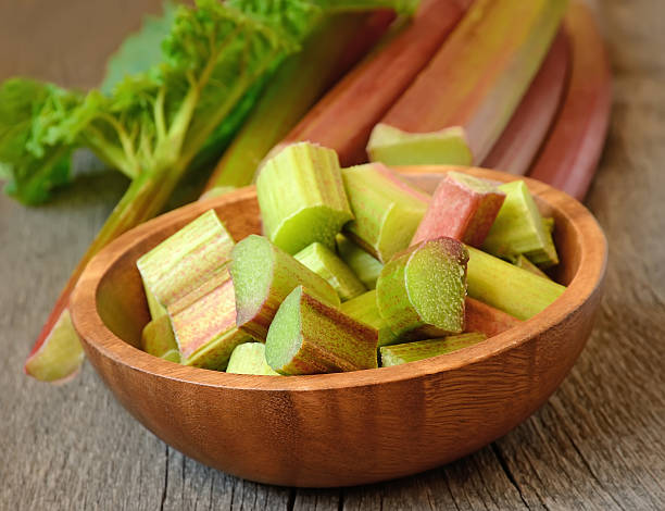 istock Fresh rhubarb on wooden garden table 453297551