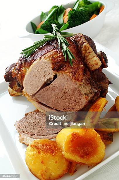 Roast Leg Of Lamb With Seasonal Vegetbles Stock Photo - Download Image Now - Animal Body Part, Animal Leg, Animal Limb