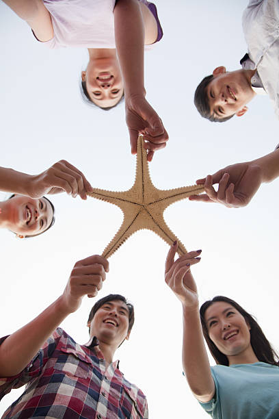istock Group of Friends Holding a Starfish 453305363