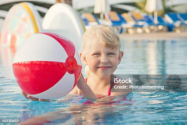 Child Playing With Ball In A Swimming Pool On Holiday Stock Photo - Download Image Now
