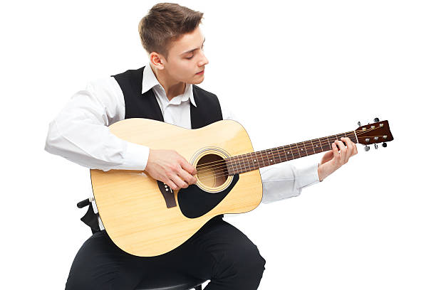 istock Young man playing on acoustic guitar 453306879