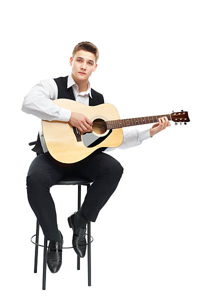istock Young man playing on acoustic guitar 453307127