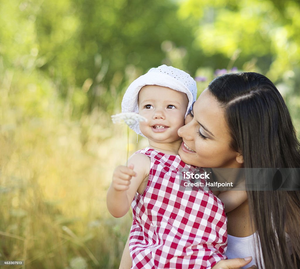 Happy family Happy young family spending time together in green nature. Adult Stock Photo