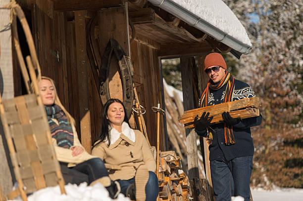 istock Young man carry wooden log winter cottage 453307521