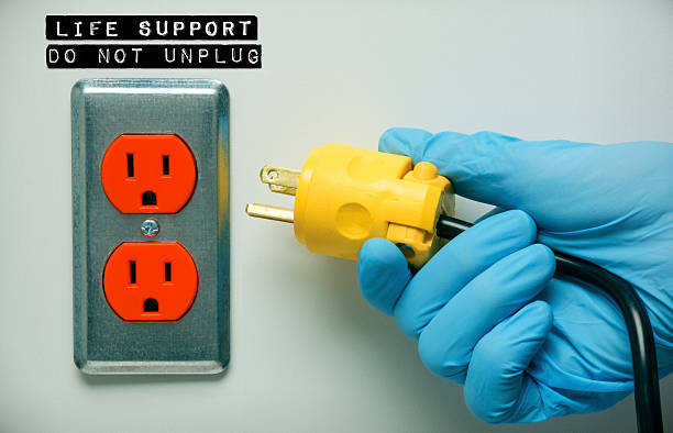 Pulling the plug on a patients life support stock photo