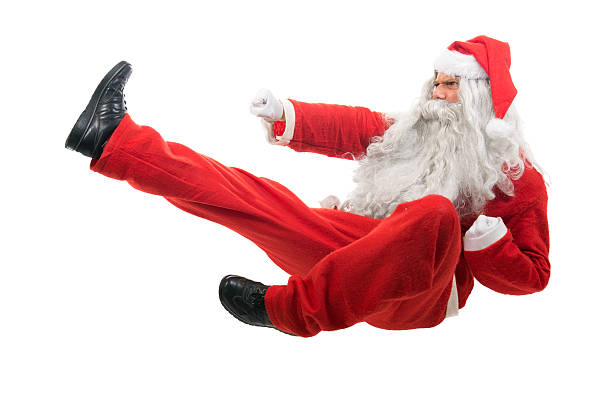 istock Santa Claus sitting on floor, mimicking karate moves 453308841