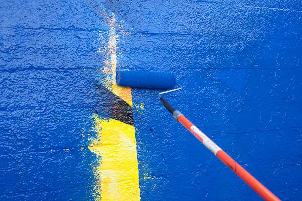 Photo of Painting over graffiti with a roller