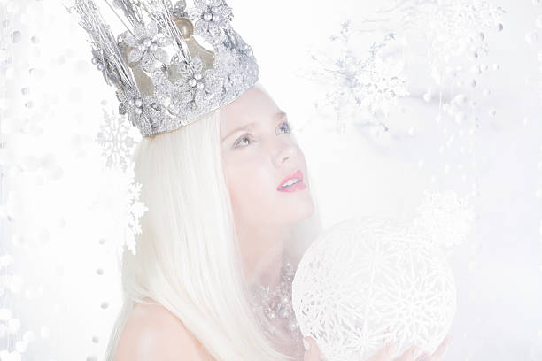 istock beautiful young woman with crown on a snow background 453309857