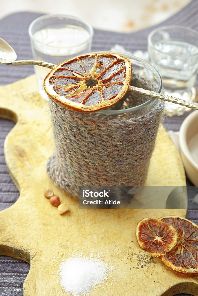 Coffee Cup Cozy Knit Coffee & Tea Cozy mug with dried orange Comfortable Stock Photo