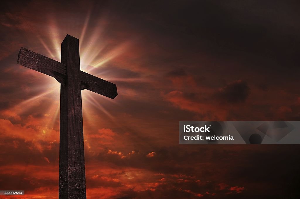 Crucifix in Sunset Crucifix in Sunset. Bright Light Above the Crucifix / Cross. Dark Red Cloudy Sky. Christian Theme. Celebration Stock Photo