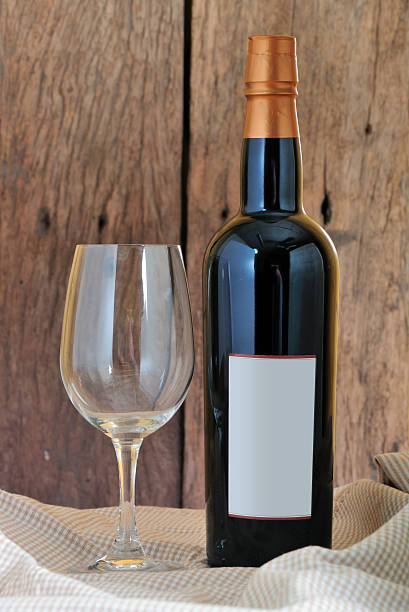 istock Empty glass near red wine on wooden background 453313215