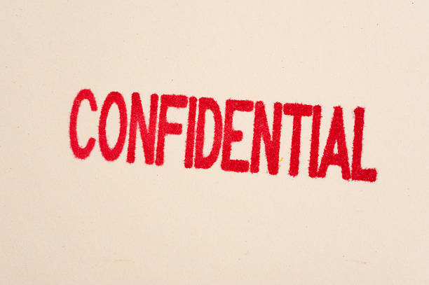 Red confidential stamp on a folder stock photo