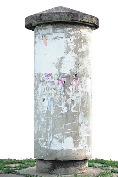 Grunge concrete advertising pillar, isolated weathered aged blank empty Advertising pillar, weathered aged grunge light grey concrete ad pole on grass, isolated empty blank copyspace, rustic background advertising column stock pictures, royalty-free photos & images