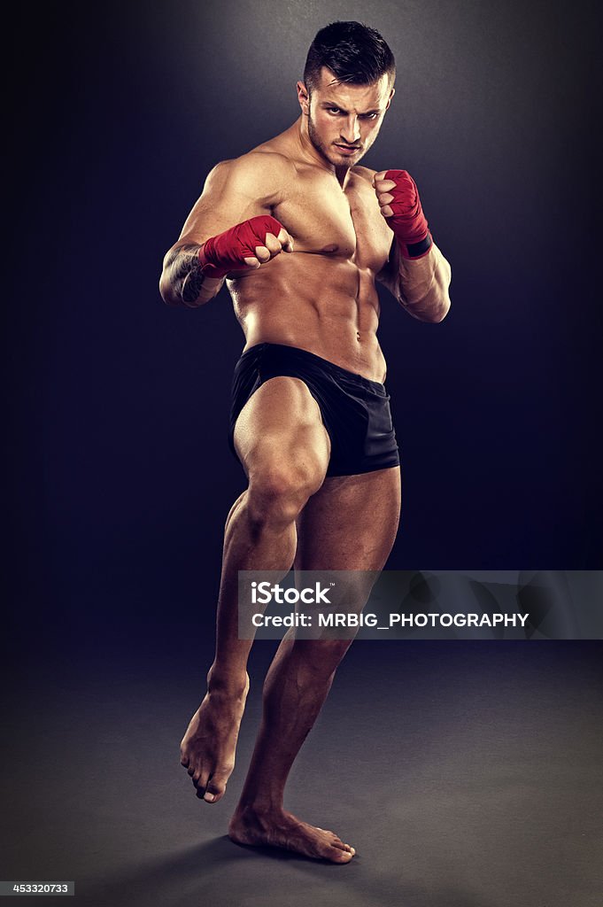 The Fighter Muscular MMA Fighter preparing for a leg kick Abdominal Muscle Stock Photo