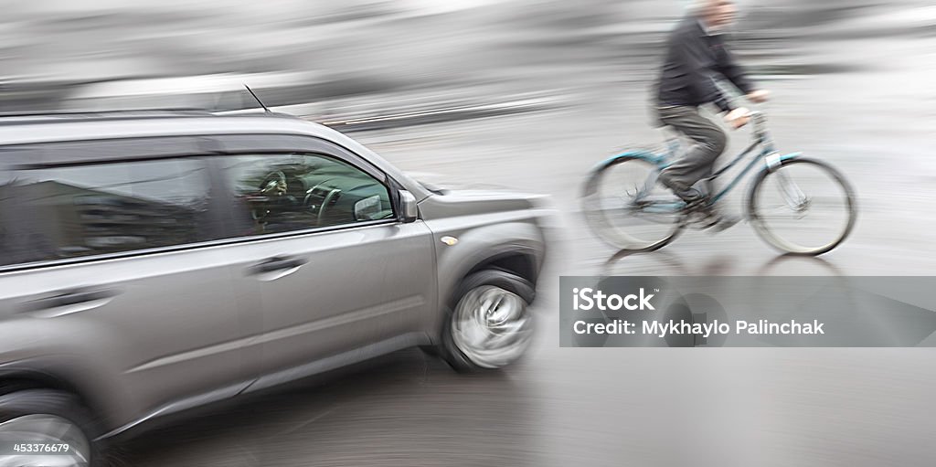 Dangerous city traffic situation Dangerous city traffic situation with a cyclist and cars in motion blur Cycling Stock Photo