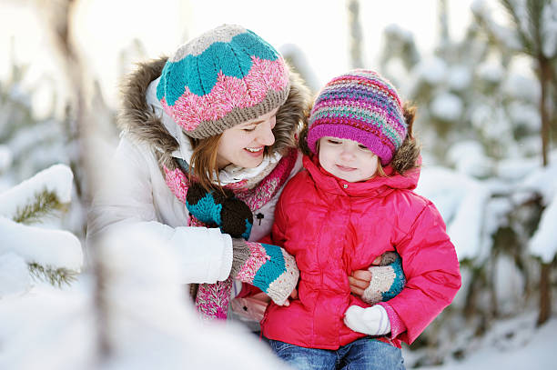 istock Happy mother and daughter playing in snow 453385935
