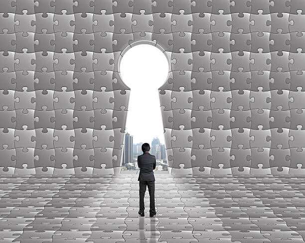 istock Businessman toward key hole on puzzles wall with city view 453387893
