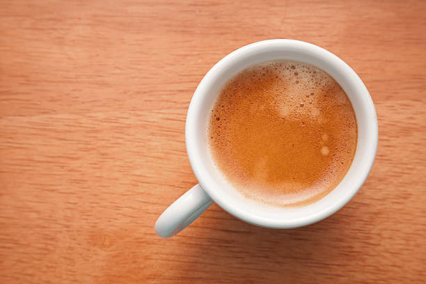 istock Small espresso cup. Top view on wooden table background 453404207
