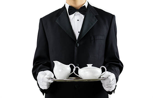Butler Service Tea Time Butler In Black Suit Serving Tea On A Silver Tray White Background silver platter stock pictures, royalty-free photos & images