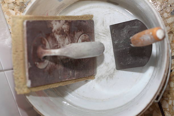 istock Old dirty trowel and bucket on building site 453409945