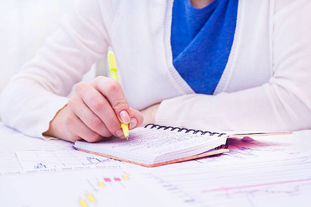 istock Business woman writing with pen in notepad 453421911