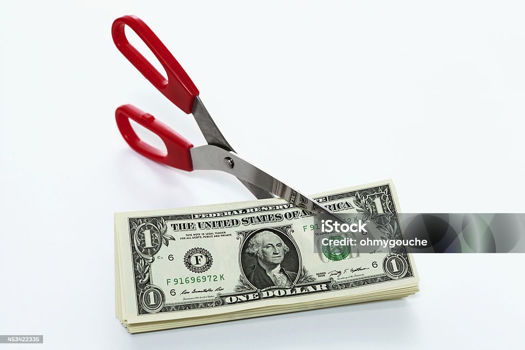 scissors cutting money Scissors cutting money Abundance Stock Photo