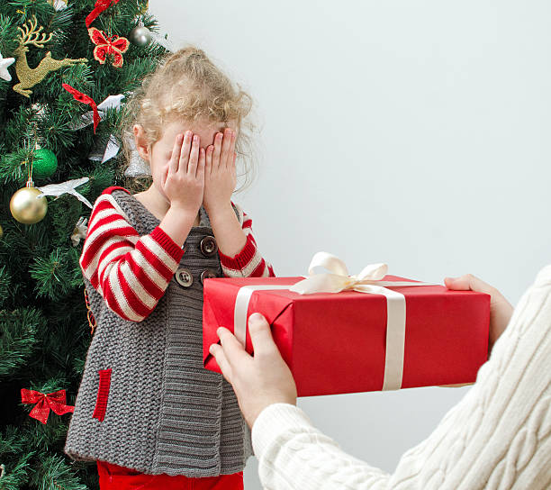 istock Man surprising little girl with christmas gift 453425133