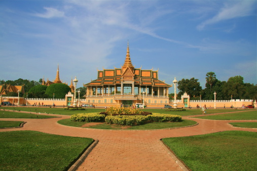 A small pavilion at the Royal Palace in Phnom Penh. Enhanced with blue sky and green grass