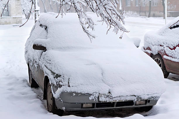 istock covered with snow car on a city street 453436291