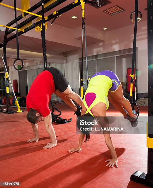 Gym Members Doing Training Exercises At Gym Stock Photo - Download Image Now - Hanging, Men, Moving Down