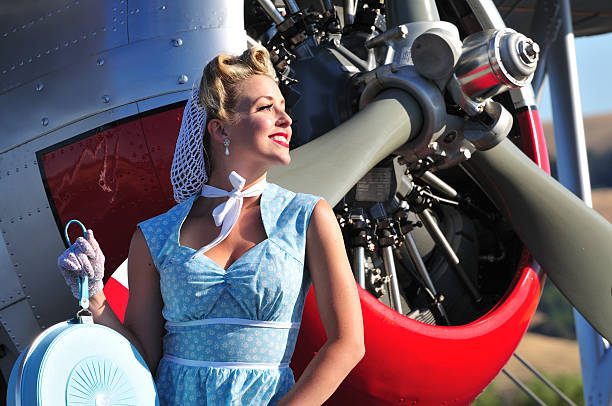 retro lady and biplane aircraft closeup of a classic 1940's lady in front of a vintage biplane 40s pin up girls stock pictures, royalty-free photos & images